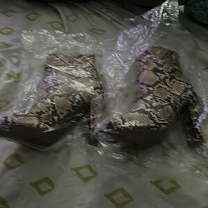 Faux snakeskin open toes high heel boots.